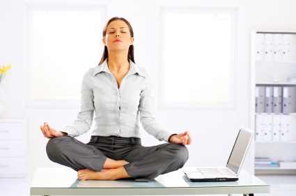 Businesswoman Meditating On Desk